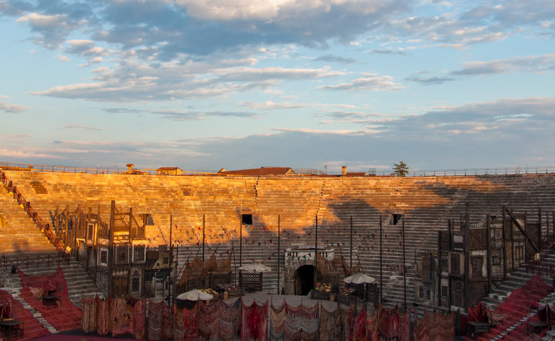 Opera set inside the Arena di Verona at sunset, during the summer opera season