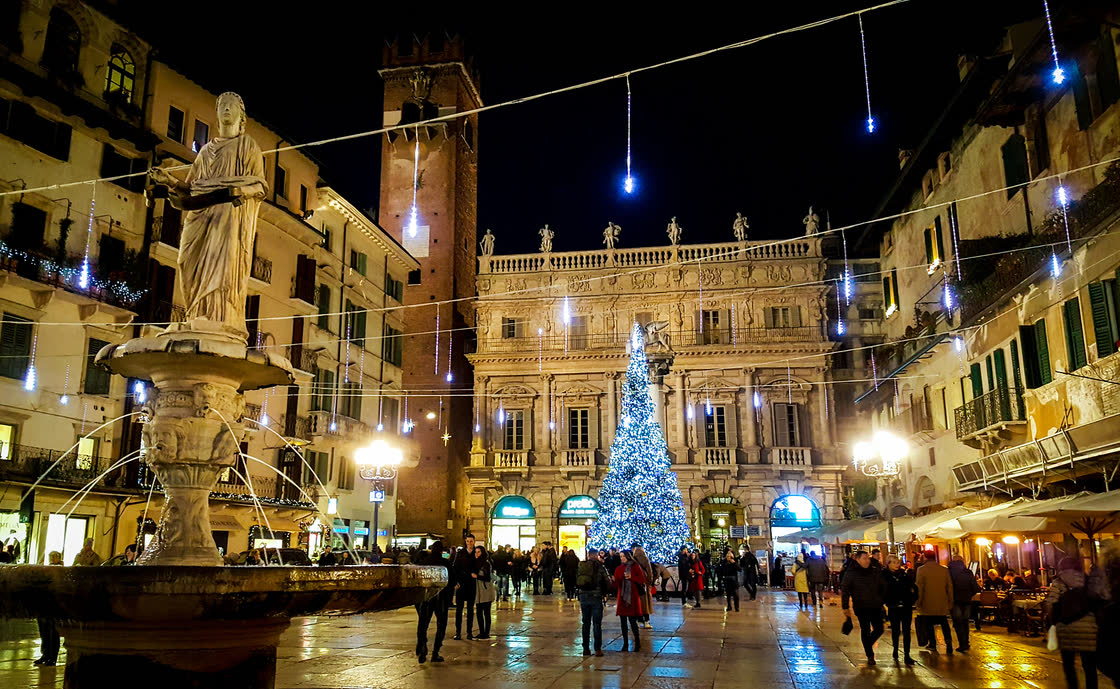 Piazza delle Erbe in Verona at Christmas, with the lit-up tree, the Christmas lights and the Madonna Verona fountain